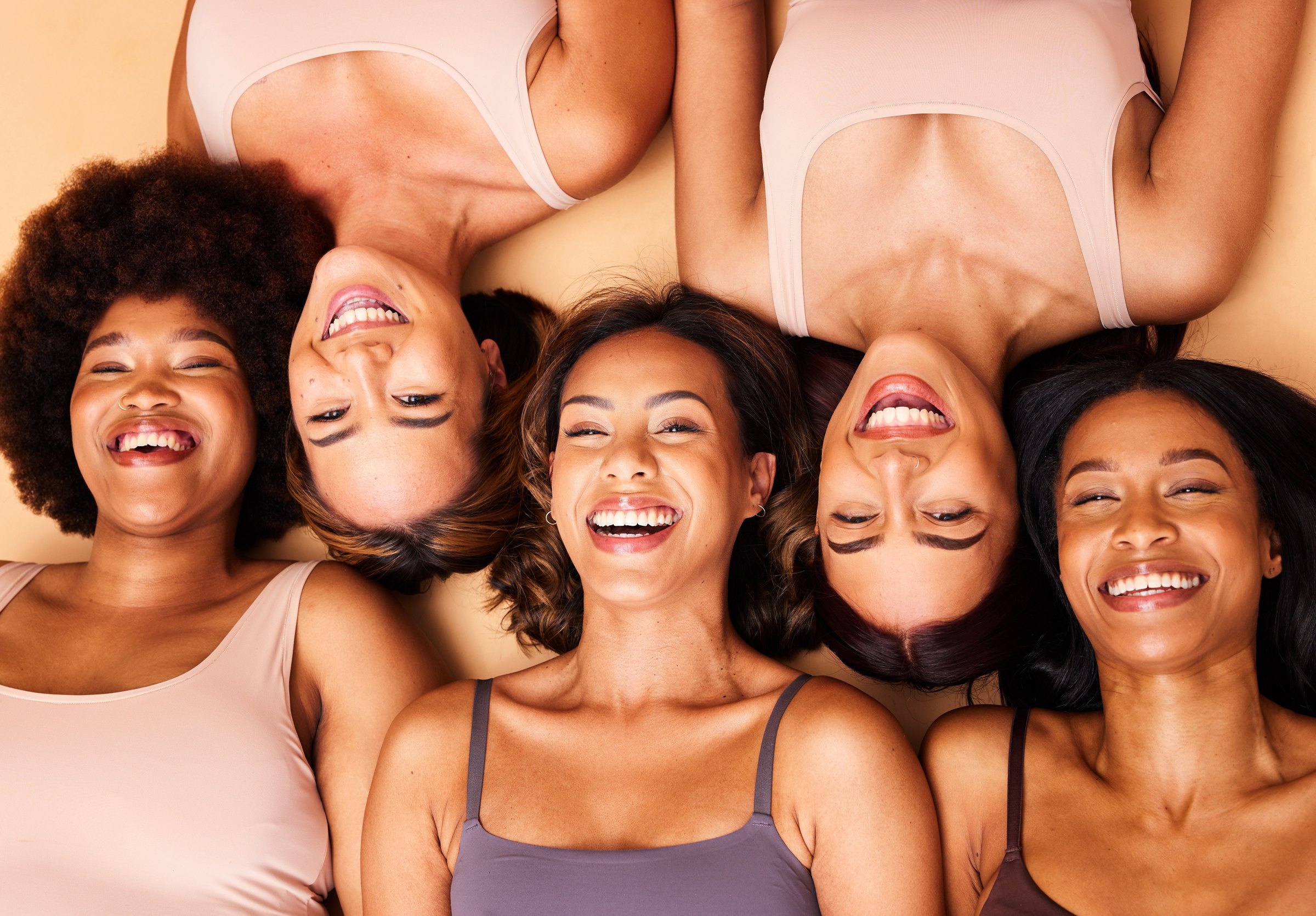 Women of diverse complexions smiling together
