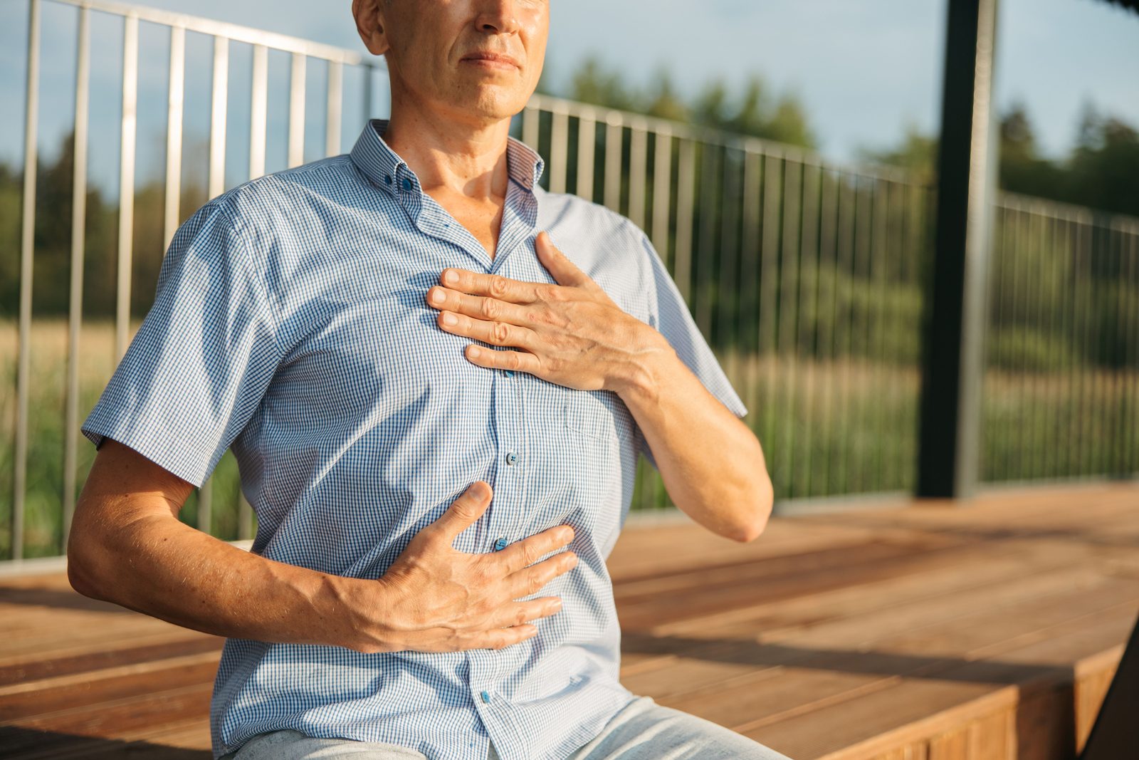 A man pausing to notice how his body feels